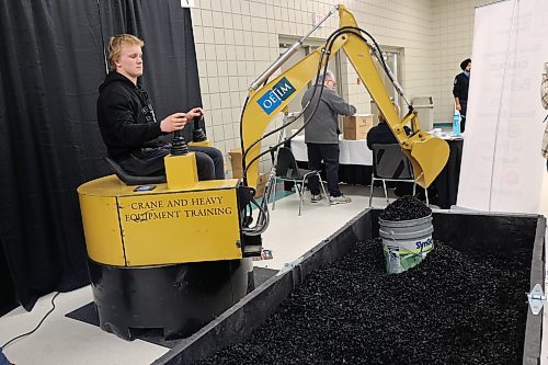 vers Collegiate grade 10 student Winston Lepp operates an excavator assimilator at the Operating Engineers Training Institute of Manitoba's booth during the Brandon Career Symposium Keystone Centre on Tuesday afternoon. (Abiola Odutoila/The Brandon Sun)