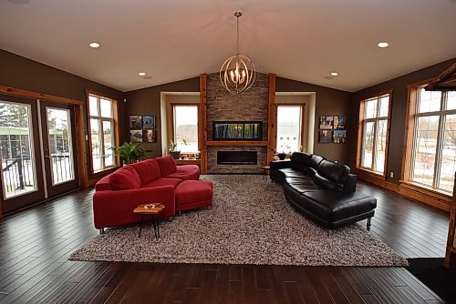 Todd Lewys / Free Press
Anchored by a gorgeous, wood-trimmed fireplace with stone backdrop and surrounded by huge windows, the newer home’s great room dazzles with its modern-rustic charm.