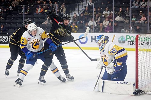 Nicholas Johnson #62 of the Brandon Wheat Kings and Ben Saunderson #2 of the Saskatoon Blades jostle in front of Blades goalie Evan Gardner #35 during WHL action at Westoba Place on Wednesday evening. 
(Tim Smith/The Brandon Sun)
