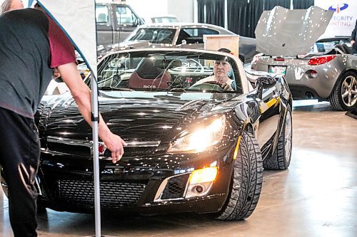 MIKAELA MACKENZIE / FREE PRESS
Doug Ashton parks his Saturn Sky Redline, nicknamed Ҕhe Shadow,Ӡin preparation for the World of Wheels event at the RBC Convention Centre on Thursday, March 20, 2025.
Standup.
Winnipeg Free Press 2025