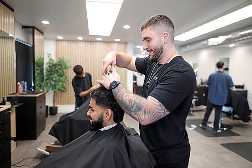 19032025
Taher Banuga, barber and part owner of Elevate Barbershop on 17th Street in Brandon, gives Preet Patel a haircut on Wednesday. 
(Tim Smith/The Brandon Sun)