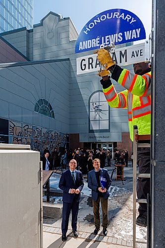 MIKE DEAL / FREE PRESS
Ian Allen with City of Winnipeg Traffic Services installs the sign while Mayor Scott Gillingham and Andre Lewis look on.
In 2025, André Lewis celebrates 50 years with Canada’s Royal Winnipeg Ballet. In recognition of his years of leadership, Mayor Scott Gillingham designats Graham Avenue between Edmonton Street and Carlton Street as André Lewis Way during a ceremony Monday afternoon outside the RWB at 380 Graham Ave.
Standup
250324 - Monday, March 24, 2025.
