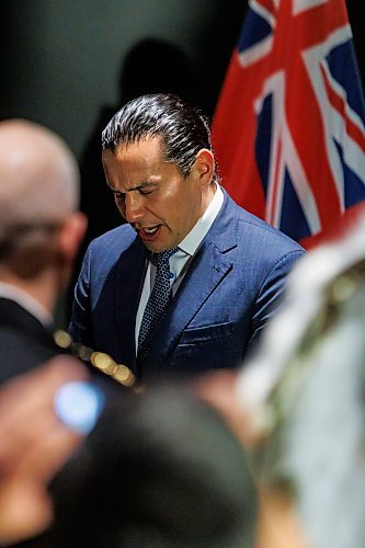Premier Wab Kinew sings a traditional Indigenous song in honour of Ashlee Christine Shingoose after her father, Albert Shingoose, made the request via phone at Wednesday's news conference in Winnipeg. (Mike Deal/Winnipeg Free Press)