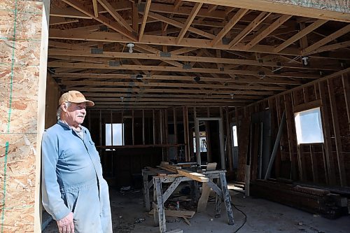 Neil Friesen stands outside his newly built garage at the site of an abandoned home in Wawanesa. Friesen plans to remodel the home then put it up for sale, after buying the property for $11,000 at an auction. (Connor McDowell/Brandon Sun)