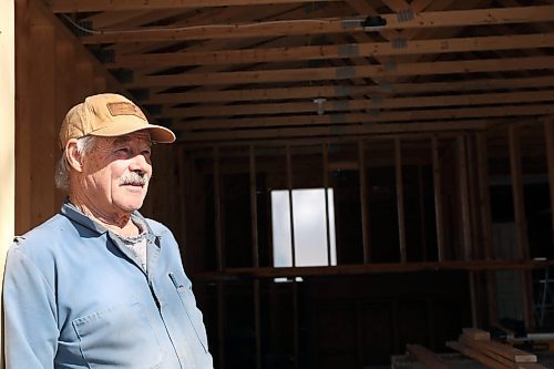 Neil Friesen stands in his newly built garage at the site of an abandoned home in Wawanesa. Friesen plans to remodel the home then put it up for sale, after buying the property for $11,000 at an auction as a retirement project. (Connor McDowell/Brandon Sun)