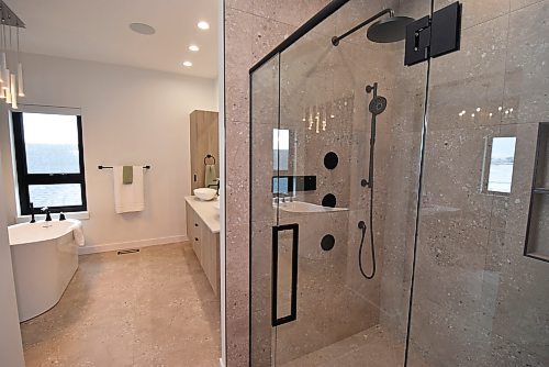 Todd Lewys / Free Press
A gorgeous walk-in shower starts off the spa-like ensuite, which also offers a freestanding soaker tub, tile floor and floating vanity with dual oval sinks.