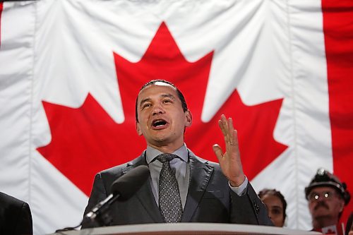 The Maple Leaf Flag hangs behind Manitoba premier Wab Kinew at the Maple Leaf Foods plant cafeteria on Wednesday afternoon as he announces $10.7 million in added support for Manitoba producer. (Matt Goerzen/The Brandon Sun)