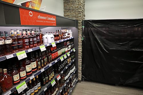 Canadian whisky is advertised at the Brandon South Liquor Mart on Tuesday afternoon while black plastic covers the American whiskey section. The Manitoba government ordered American products removed from Liquor Marts in response to tariffs imposed by U.S. President Donald Trump. (Tim Smith/The Brandon Sun)