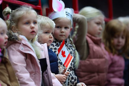 Two-year-old Winkler from Brandon holds a Canadian maple leaf flag while waiting for the Canine Circus performance to begin on Monday evening at Westoba Place. (Matt Goerzen/The Brandon Sun)
