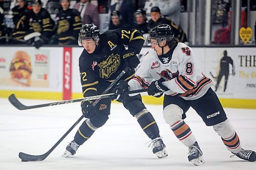 Brandon Wheat Kings forward Marcus Nguyen (72) plays the puck as Kalem Parker (8) of the Calgary Hitmen tries to obstruct him at Westoba Place in February. (Tim Smith/The Brandon Sun)