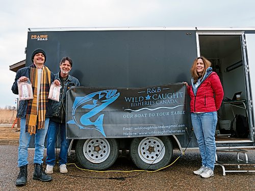 Robinson, standing with son Lucas (left) and wife Angie Bell, displays the family company's brand. The family has been fishing for six generations. (Weichen Zhang/The Brandon Sun)
