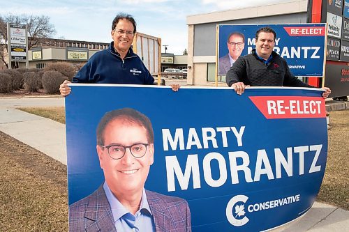 BROOK JONES/FREE PRESS
Incumbent Conservative candidate Marty Morantz (left) holds a large re-elect campaign sign with his campaign manager Michael Kowalson while the duo are pictured alongside Portage Avenue in Winnipeg, Man., Thursday, April 17, 2025. Morantz, who is a two-term Conservative incumbent, is running in the federal riding of Winnipeg West.