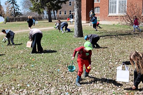 Some children pick eggs across the lawns of Assiniboine College’s North Hill Campus for the college’s annual Easter Eggstravaganza Saturday afternoon. (Abiola Odutola/The Brandon Sun)