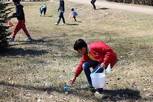 Some children pick eggs across the lawns of Assiniboine College’s North Hill Campus for the college’s annual Easter Eggstravaganza Saturday afternoon. (Abiola Odutola/The Brandon Sun)