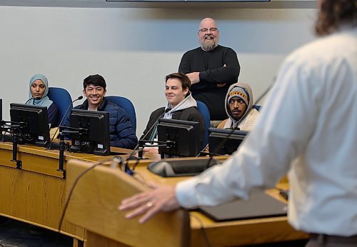 Coun. Shaun Cameron has a chuckle as Mayor Jeff Fawcett speaks to students during their tour of city hall on Thursday. (Michele McDougall/The Brandon Sun)