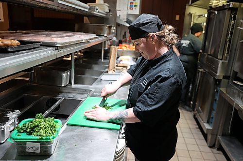 Brandon’s based Casey Naherniak chops parsley in The Keg's kitchen Saturday afternoon. (Abiola Odutola/The Brandon Sun)