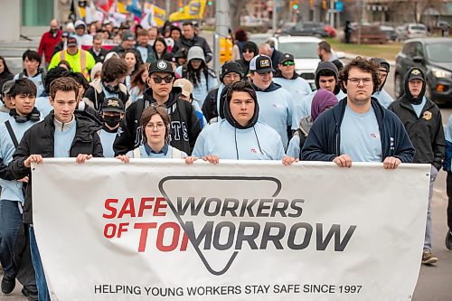 BROOK JONES/FREE PRESS
SAFE Workers of Tomorrow Leader's Walk participants march along Broadway Avenue in Winnipeg, Man., Monday, April 28, 2025. Students from Tec Voc High School, Collège St. Norbert Collegiate and Collège Lorette Collegiate volunteers carry the banner at the front of the walk. In addtion to the Leaders' Walk, a ceremony to remember Manitobans who died last year after suffering injuries or illness at work took place at the Manitoba Workers Memorial which is also known as Fallen Firefighter Memorial at Memorial Park in Winnipeg.