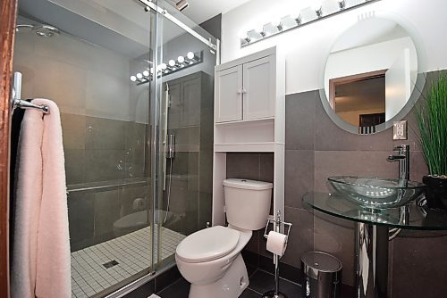 Todd Lewys / Free Press
Anchored by a gorgeous walk-in shower with sliding tempered-glass doors and two-tone tile surround, the main bathroom is a luxurious, spa-like space.