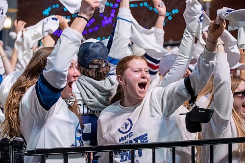 BROOK JONES/FREE PRESS
Winnipeg Jets fans Leah Clausser (middle), Gabbry Robbins (left) and Kennedy Peters cheer after the Jets score their team's first goal of the Game 5 in the National Hockey League Stanley Cup playoff between the hometown Winnipeg Jets and the visiting St. Louis Blues in Winnipeg, Man., Saturday, April 19, 2025. The Winnipeg Jets Whiteout party tooks place on Donald Street between Portage Avenue and Graham Avenue.