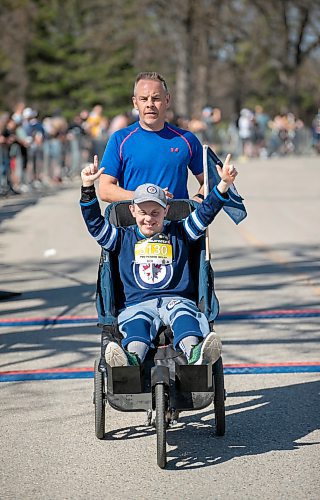 BROOK JONES/FREE PRESS
Nick Cauthers raises his arms as he crossed the finish line with his brother Chris Cauthers who was his running guide in two person relay for the WPS Half Marathon at Assiniboine Park in Winnipeg, Man., Sunday, May 4, 2025. Nick's teammate in the two person relay was Luis Melchor.
