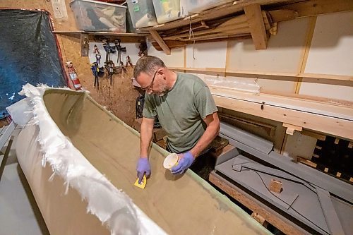 BROOK JONES/FREE PRESS
Paddle and Hum owner Myron Sawatzky builds lightweight solo canoes in a backyard shed he converted into his workshop. The North Kildonan resident is pictured appling epoxy resin to the interior hull of a fiberglass canoe he is building in his workhop in Winnipeg, Man., Monday, May 5, 2025.