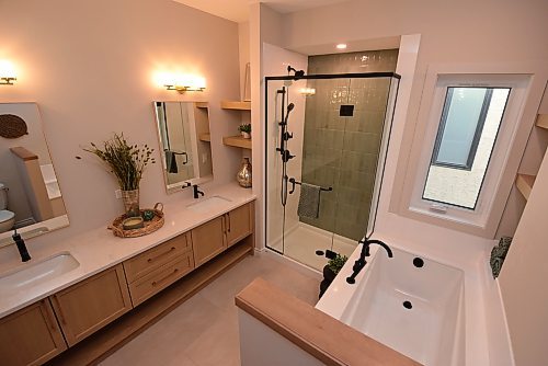 Todd Lewys / Free Press
The spa-like ensuite comes with a gorgeous, tiled walk-in shower and deep soaker tub that’s a perfect retreat at the end of a long day.