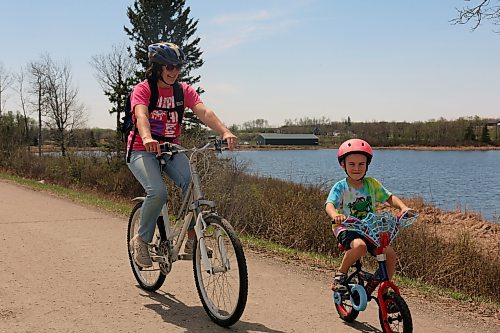 Malik Morrison, 5, takes his first solo bike ride on the shoulder of Highway 10 north of Onanole. His mother Ludivine Morrison rides with him, she said she hopes the area will be slowed to a speed of 60 km/h rather than 80 as people use it to get to town. The Morrison family lives north of Onanole. (Connor McDowell/Brandon Sun)