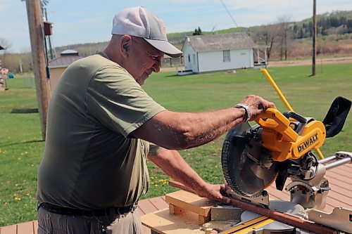 Ed Bilcowski saws a piece of wood trim for a four-tier garden planter that he and the Minnedosa Men's Shed will donate to the Little Valley Jamboree in June. The planter will go up for auction, with proceeds going to support three children who are living with serious medical conditions. (Connor McDowell/Brandon Sun)