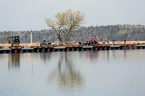 The marina at Clear Lake is closed for work in May as the summer season approaches. Crews hauled stones to the marina through the morning. Parks Canada last year said repairs include that large rip rap will be placed along the sides of the pier, as well as vegetation planted to reinforce the soil and enhance the habitat for species in the area. A new sheet piling wall was planned to be installed, as well as construction of a new timber boardwalk. Parks Canada said the project eliminates safety risks to visitors and staff and produces a permanent solution to protect the resource for Riding Mountain National Park. (Connor McDowell/Brandon Sun)