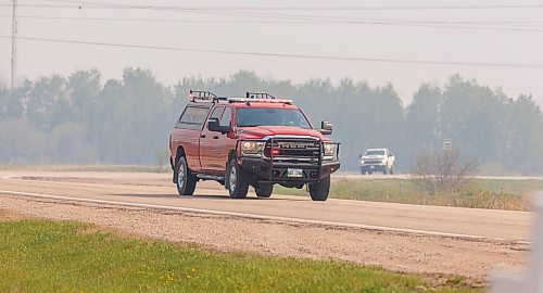 MIKE DEAL / FREE PRESS
Emergency vehicles leave the closed zone on Lee River Road.  
Lac du Bonnet wildfire has displaced as many as 1,000 people, and the community has really pulled together to help each other out.
Reporter: Nicol Buffie
250514 - Wednesday, May 14, 2025.