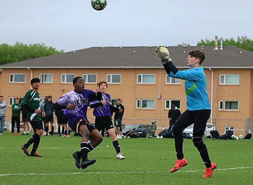 Vincent Massey's Jedaiah Matendo watches as Neelin goalkeeper Devin Perreault charges a floating ball. (Matt Packwood/The Brandon Sun) 