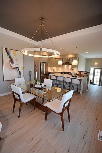 Todd Lewys / Free Press
Defined by a stylish tray ceiling and circular chandelier, the striking dining room opens onto the elegant island kitchen.