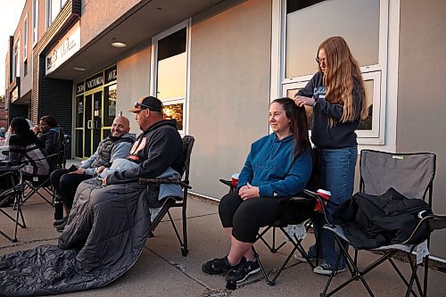 28052025
Sophie Drohan styles her mom Leslie’s hair while passing time in line outside the doors of Guild Insurance Group on Victoria Avenue at sunrise early Wednesday morning. The Drohan’s arrived at 4:30AM to secure a spot in line in hopes of registering Sophie for the Driver Z provincial driver's education program. The line of students and parents wrapped around two sides of the building, with many having arrived overnight. There were also lines at Westland Insurance and Western Financial Group. Many parents and teens are frustrated that Manitoba Public Insurance is not meeting the demand for the program.
(Tim Smith/The Brandon Sun)