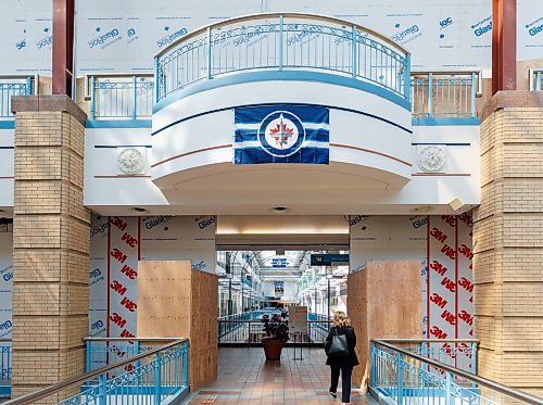 MIKE DEAL / FREE PRESS
A temporary doorway on the second level of the mall provides access through the newly constructed wall which will close off the Mall from the Clocktower atrium that will be removed for an access road to help facilitate construction of the Pan Am Health Centre for Excellence.
Visible signs that True North is making progress on the redevelopment of Portage Place Shopping Centre have arrived and soon access to the building will be shifted to allow for the removal of the Clocktower atrium. The main mall area will still be accessible, including access to Prairie Theatre Exchange, but the main access from Portage Avenue will move to the entrance at Portage and Kennedy Street. The entrances at Portage and Edmonton and Portage and Carlton will be closed as well as the skywalk at the Carlton Street intersection. The Parkade entrance and exit on Carlton will be closed. These changes will start in July and continue for three years.
Reporter: Malak Abas
250526 - Monday, May 26, 2025.