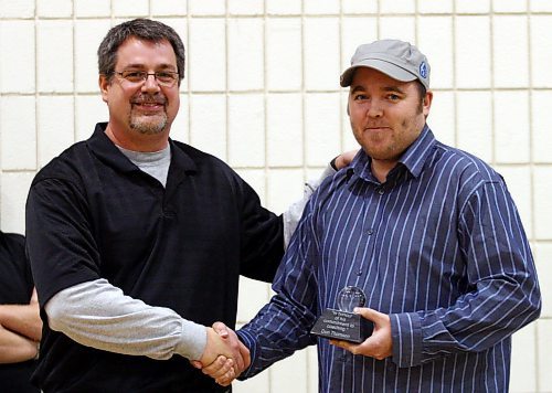 Legacy Brandon Sun 14122007 TIM SMITH/BRANDON SUN Neelin HS Basketball coach Don Thomson is presented with the Brandon SUN Spartan Invitational Coaching Award by Brandon SUN sports writer David Larkins at the Neelin HS gym on Friday.