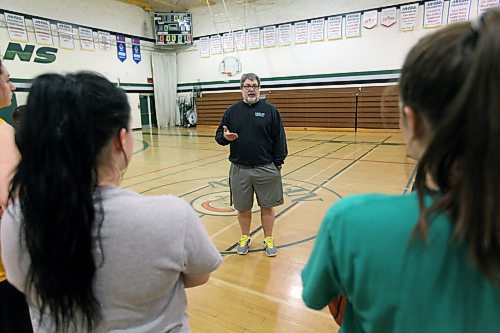 Brandon Sun 18032014 Coach Don Thomson of the Neelin Spartans varsity women's basketball team addresses players during practice on Tuesday evening. (Tim Smith/Brandon Sun)