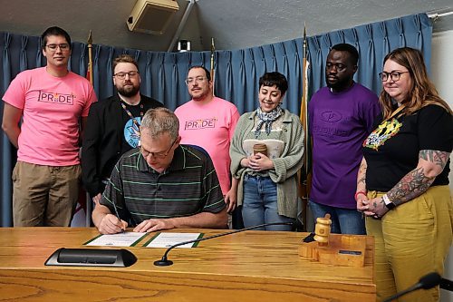 02062025
Brandon Ward 6 Councillor Bruce Luebke, in his role as Acting Deputy Mayor of the City of Brandon, signs a proclamation recognizing June 2025 as Pride Month in the wheat city while joined by Steven Ternovetsky, Derek Booth, Ian Ternovetsky and Han Van De Woestyne with Brandon Pride as well as Friday Olowookere and Kaitlyn White with SERC Brandon. The proclamation was the first in a month of events organized by Brandon Pride.
(Tim Smith/The Brandon Sun)