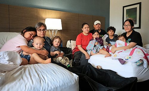 Ruth Bonneville / Free Press
Local WILDFIRES HOTELS:
Photo of the extended family from Cross Lake living in one of two hotel rooms at the Victoria Inn. The children are very upset about their little dog Buzy not being able to stay with them in the hotel room. Dog is being fostered by Manitoba Animal Alliance.
Names from left:
Belinda McKay (7yrs)
Bernice Moore (grandmother to all the kids in picture)
Jenson McKay (baby in stripes)
Davair Ross-Moore (1yr old grandson)
Group on Right side:
Darrylee McKay (red, mom and auntie)
Orville Frogg (white hat, Darrylee’s partner and dad)
Suzie McKay (girl, plum shirt)
Okay McKay (boy 10yrs)
Demi Moore (glasses, mom holding daughter Divena)
Divena Moore (2yrs)
Story on evacuees making their home in local hotel, Victoria Inn and the circumstances surrounding getting a room, their pets etc.
See story by Scott
June 3rd, 2025