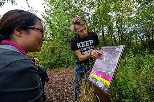 Daniel Crump / Winnipeg Free Press. Riley Martin (right) takes people on a guided walk of Assiniboine Forest, one of the largest urban natural areas in North America. The walk is part of a CPAWS campaign urging mayoral candidates to pledge to protect Assiniboine Forest as a National Urban Park. September 24, 2022.
