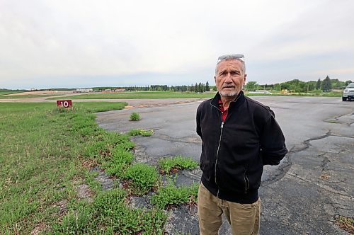 David Pedersen, a pilot who advocates for airports in the southern prairies, stands at the International Peace Gardens Airport on the border with the United States. While the United States performs work on its side of the airport, Pedersen wants the province to strike a deal to expand the Canadian side into surrounding grass and bush area. Without investment, the Canadian side will be decommissioned in eight to 15 years. The Canadian parking pad is seen below Pedersen's feet, and is the only infrastructure at the airport on the Canadian side of the border. The yellow paint and red sign depict the border line with America. (Connor McDowell/Brandon Sun)