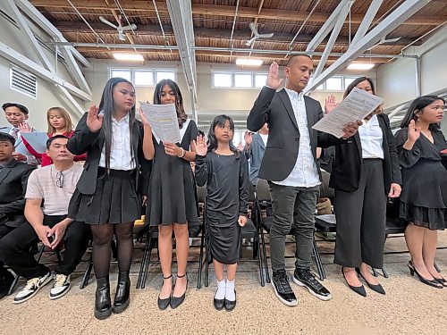 A row of new Canadians take the oath of Canadian citizenship. (Matt Goerzen/The Brandon Sun)