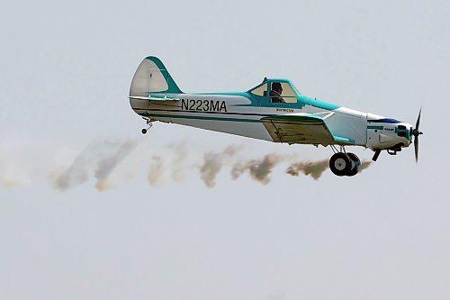 A Piper Pawnee remote-controlled plane is flown by Ian Fraser (not shown) at the Brandon RC Flying Club field east of Brandon this month. The smoke visual effect is created when Fraser, standing on the grass below, triggers a remote to push special oil into the muffler. The trick leaves a trail of smoke behind the aircraft as it soars over the landing strip. The machine is modelled after a real aircraft that was designed as an agricultural aircraft and is commonly used for "crop dusting," flying over fields of crops and spraying chemicals to protect against pests. (Tim Smith/The Brandon Sun)