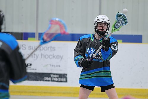 Ruby Hatcher catches a pass in a lacrosse game in Rivers. (Matt Packwood/The Brandon Sun)