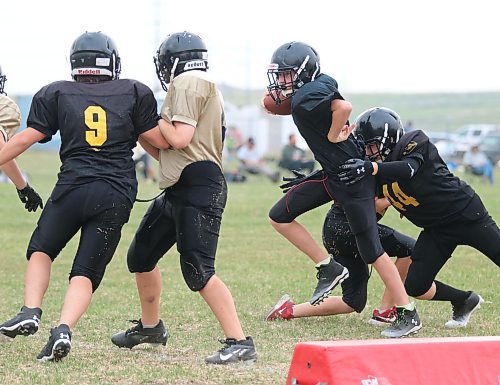 Jack Murray tries to shed a tackle in his pee wee football team's practice Thursday evening at Boyd Stadium. Westman Youth Football Association hosts the final home games of the season this Saturday at Boyd Stadium. (Matt Packwood/The Brandon Sun)