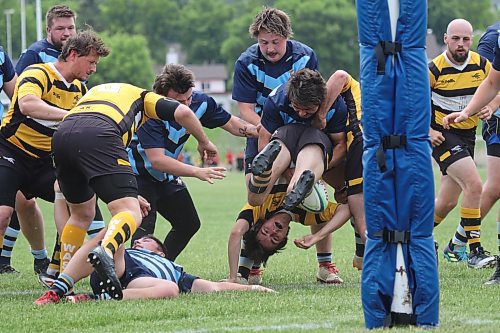 Brandon Barbarians Richard Pierreroy flips a Winnipeg Wasps ball carrier upside down during their Rugby Manitoba men's Division 2 game at John Reilly Field on Saturday. (Thomas Friesen/The Brandon Sun)