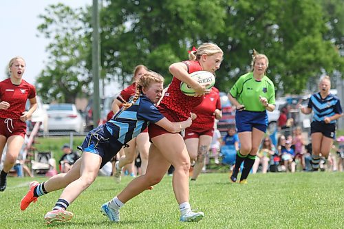 Brandon Barbarians Julie Osis tackles Dauphin Mavericks Bree Walker during their women's rugby game at John Reilly Field on Saturday. (Thomas Friesen/The Brandon Sun)