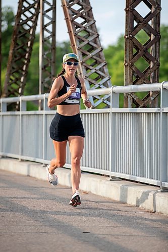 BROOK JONES/FREE PRESS
Elizabeth Tomczak of Regina, Sask., crosses the BDI bridge while she competes in the half marathon at the Manitoba Marathon in Winnipeg, Man., Sunday, June 15, 2025. women's half marathon with a time of 1:22:14. Tomczak placed third in the women's half marathon with a time of 1:24:52.