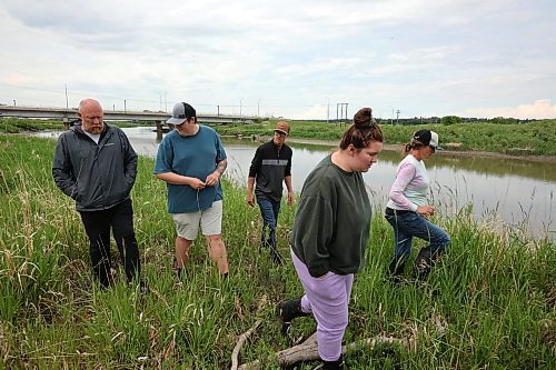 Ward 10 Coun. Tyson Tame (left) and others search the south bank of the Assiniboine River east of 18th Street for his missing nephew, Owen Bedford, on Monday. (Tim Smith/The Brandon Sun)