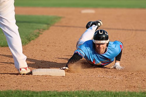 Brandon RFNOW Cardinals shortstop Paycen Warkentin dives into first base on a pickoff attempt. (Matt Packwood/The Brandon Sun) 