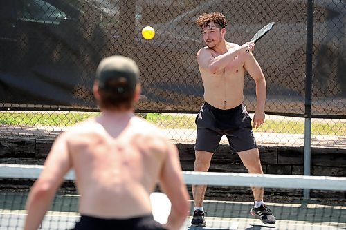 18062025
Calen Addison returns the ball while playing pickleball with friend Chad Nychuk at the Stanley Park pickleball courts on a hot Wednesday afternoon. 
(Tim Smith/The Brandon Sun)